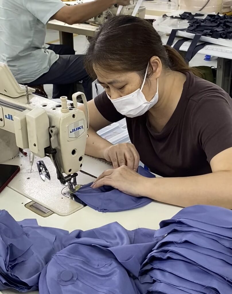 Worker using sewing machine at a professional men's underwear manufacturer